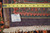 10x13 Persian rug back showing tight hand knotted wool rows, warehouse tag and tape measure