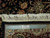Ruler placed on rug edge confirming authentic hand-knotted construction, fine knot count and cotton fringe