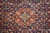 Close-up of orange and ivory center medallion surrounded by marine blue Herati fish lattice
