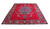 10x13 red Persian Tabriz rug shown at an angle, highlighting overall scale and border framing