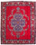 Full view of red Persian Tabriz rug with navy floral medallion and ivory shield borders