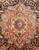 Salmon and ivory 8 point star medallion centered on near black field, blue rosette core