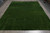 8 x 10 green hand-knotted rug photographed flat on grey tile showing full field