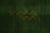 Gold zigzag mountain motif woven into the dark green field of this contemporary Indian rug