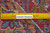 Back of the 9'5" x 12'10" Kashmar rug with ruler confirming authentic hand-knotted wool construction