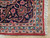 Corner detail with light blue guard border, red selvedge binding and clean ivory cotton fringe