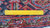 Reverse of the rug with metric ruler laid across knot rows on cotton foundation
