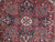 Close-up of the 8 petal ivory rosette at the center of the navy stepped medallion