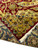 12' x 14'10" Indian rug folded to show gold guard border and ivory cotton fringe