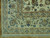 Corner detail with ivory guard stripes, blue palmette border and hand-knotted wool fringe on parquet