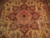 Close-up of the rust and brown 8 point star medallion with sage green leaves
