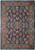 Navy blue field with coral and cream floral sprays across this hand-knotted Persian Sarouk rug