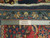 Back of the 7x10 Sarouk rug with ruler and Authentic Handmade label over cotton foundation