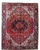 9x12 Persian Heriz rug shown flat with jet black star medallion on deep red field