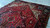 9'10" x 13'2" Heriz rug on a concrete floor showing wool sheen and even pile