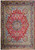 Red field Persian Sarough rug with navy floral medallion and pastel blue spandrels, full overhead view