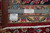 Back of the 10x13 Sarough rug with ruler, Authentic Handmade label and inventory tag 6341