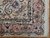 Corner detail showing rose-pink main border, navy outlines, ivory guard stripe and clean cotton fringe