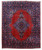 Full view of 10'3 x 12'7 Persian Mashad rug with rust red field and blue medallion