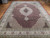 Angled floor view of the 9'10" x 13'2" Mahi rug, cream border and corner spandrels