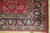 Corner detail showing black main border, gold guard stripes and clean ivory cotton fringe