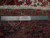 Back of the 10x13 Heriz rug with ruler confirming hand-knotted wool weave and cotton foundation