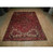 Full 8' x 11'6" Persian Heriz area rug displayed flat in warehouse showroom lighting