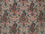 Close-up of dense wool pile showing rose, teal and ivory boteh motifs with fine knotting