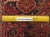 Ruler laid across the hand-knotted wool pile to show knot density and construction