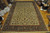 13'3" x 19'2" Tabriz rug photographed on hardwood showroom floor showing its true ivory tone