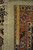 Reverse of the rug with ruler laid across the border, showing fine even knot density