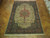 9'8" x 14' Tabriz Persian rug laid on parquet floor showing full medallion layout