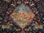Close-up of landscape medallion showing snowy mountain, grazing deer and blossoming fruit trees