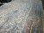 Close view of pink spandrel, teal border and blue medallion on ivory Kerman wool rug