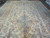 Overhead shot showing central blue medallion, ivory ground and pale blue floral border panels