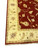 8'4 x 19'6 Indian rug corner showing ivory border, red field and cotton fringe