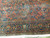 Close view of coral field meeting navy border with floral sprays in teal, gold and ivory