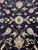 Ivory and rust rosette detail on midnight black ground with curling cream vine tendrils