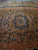 Star medallion with 8 petal rosette centered on salmon field of oversize antique Persian rug