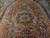 Wide view of the elongated medallion showing coral drift, blue blossoms and ivory leaf outlines