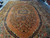 Angled full view of 11x18 antique rug showing overall medallion layout and navy outer border