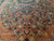 All over floral field of detached sprays, heart motif and blue rosettes on coral wool