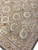 Corner detail showing pink guard border, scrolling acanthus vines and circular floral cartouches in pastel wool