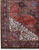 Corner detail with navy main border, rosette motifs and ivory cornerpiece of this Persian Heriz