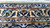 Woven signature cartouche in the border marking this Kashan as a named workshop piece