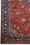 Corner view of the multiple light blue guard borders, ivory outline and hand-knotted wool fringe
