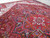 10x13 Persian Heriz rug on floor showing thick wool pile and blue serrated leaf motifs
