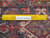 Back of the wool Heriz rug with ruler against the knots, confirming authentic hand-knotted weave