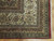 Corner detail showing multiple ivory and gold guard borders, red selvage and clean cotton fringe