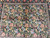 7x8 wool and silk rug close up of pale blue, gold and rose blossoms